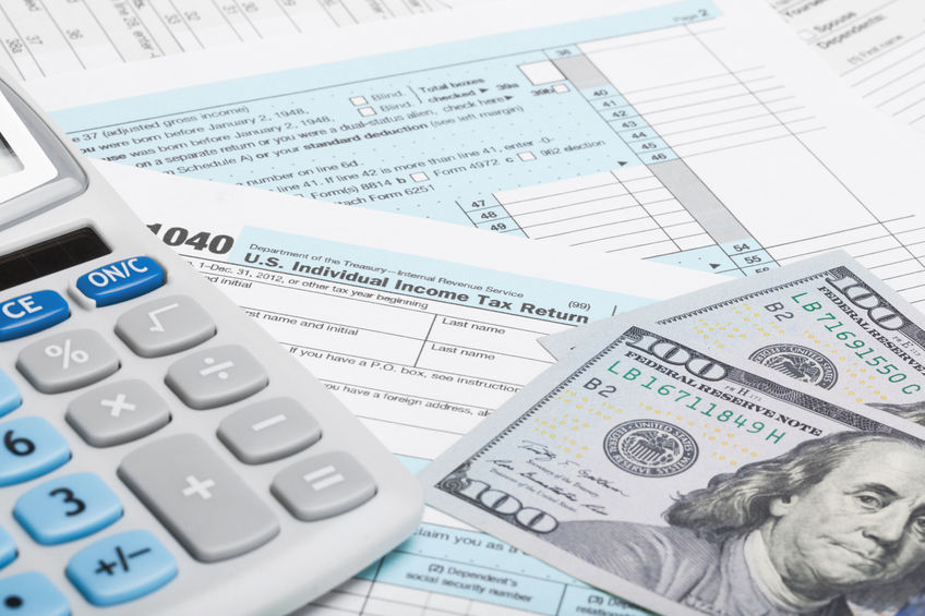 tax form 1040 with calculator and us dollars