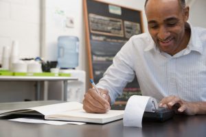 Small business owner doing taxes in cafe