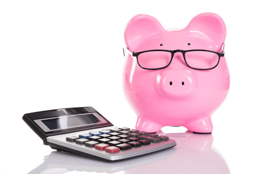 Piggy Bank wearing glasses next to calculator